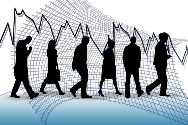silhouettes of people in business attire, walking in front of a large economic chart