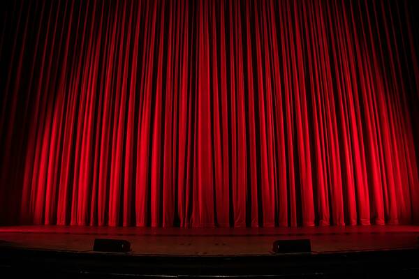 A dimly lit stage curtain