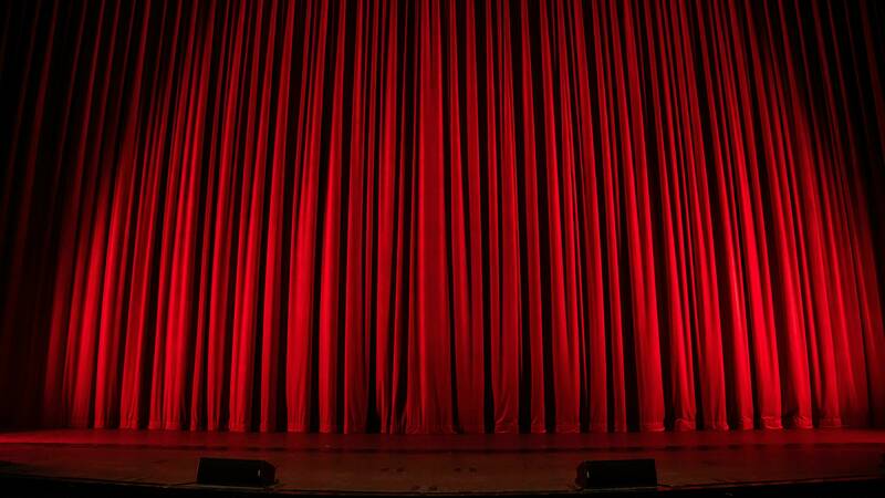 A dimly lit stage curtain
