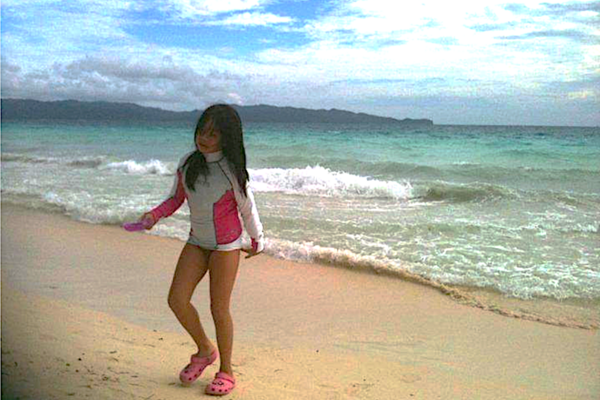 The author in her youth, on the sandy beaches of Boracay