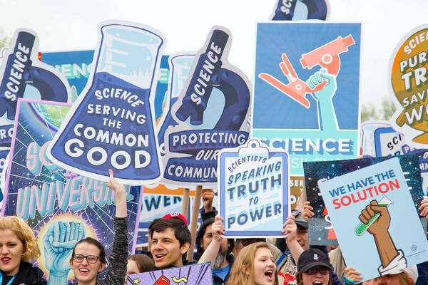 Protest signs praising the work of science