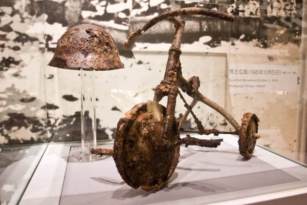Tricycle and metal helmet from the Hiroshima Peace Museum