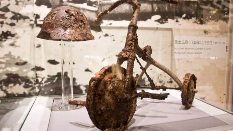 Tricycle and metal helmet from the Hiroshima Peace Museum