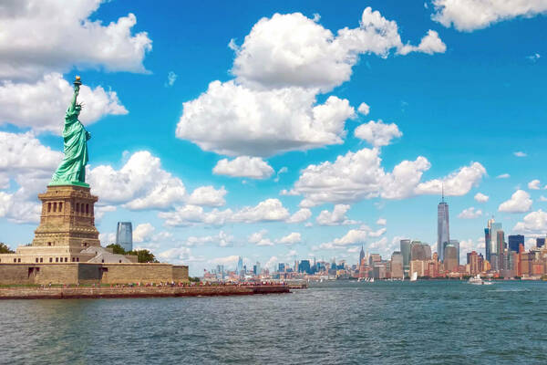 Statue of Liberty with blue sky and Manhattan in the background