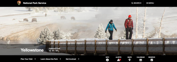Screenshot of display photo for Yellowstone documentary. Shows two people dressed for winter walking across a bridge