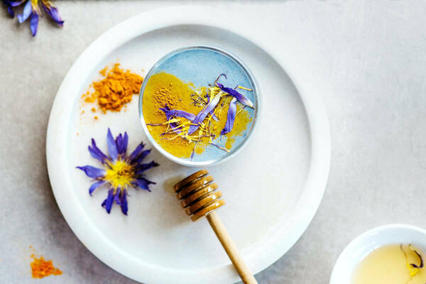 Image of natural and alternative medicines, with flowers, turmeric, and honey