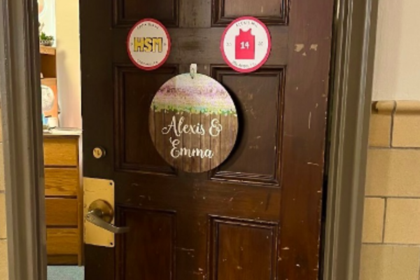 Photo of author's dorm-room door, with various signage and slightly ajar
