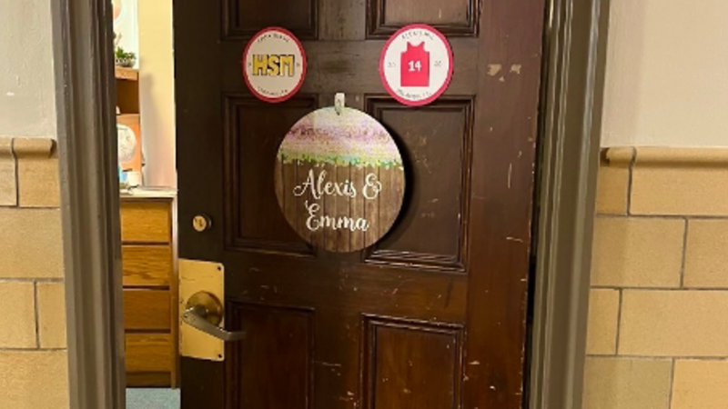 Photo of author&#39;s dorm-room door, with various signage and slightly ajar