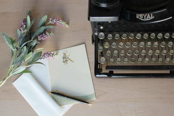 Image of typewriter with laurel-like flower