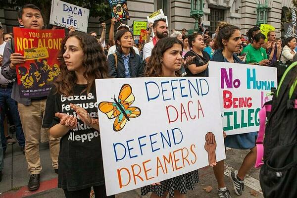 People holding signs in support of DACA and Dreamers at a rally in San Francisco