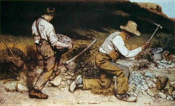 two men at work with one  breaking stones with another carrying stones in a basket