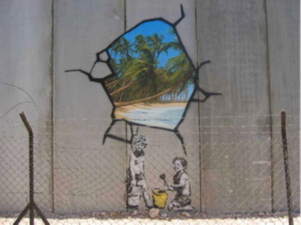 Graffiti on a wall of children breaking through to a tropical scene