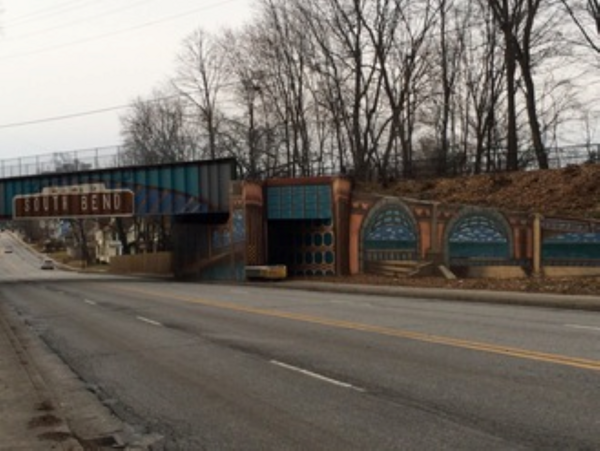 A bridge with graffiti as the entrance to South Bend