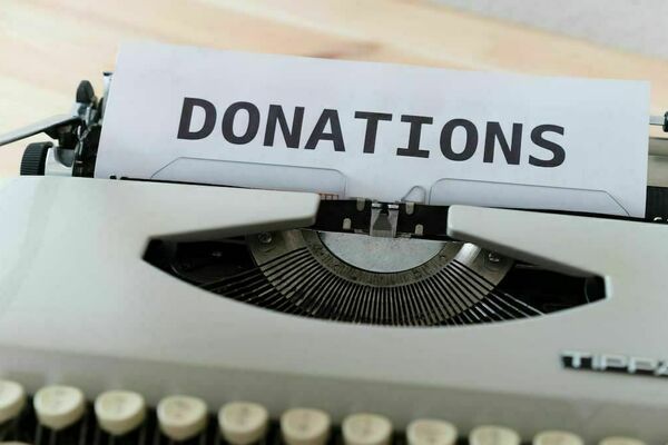 A typewriter with the word "Donations" visible in the platen.