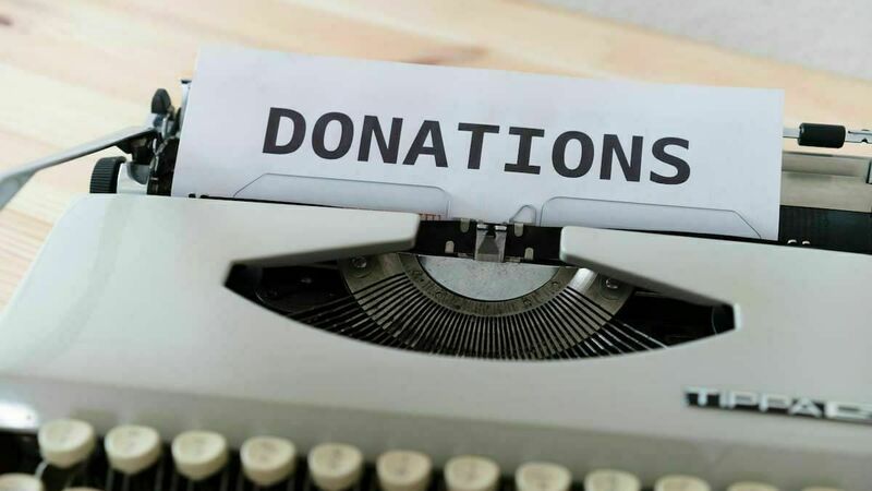 A typewriter with the word &quot;Donations&quot; visible in the platen.