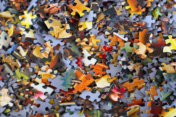 a pile of multi-colored puzzle pieces