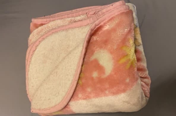 a folded pink and yellowish blanket