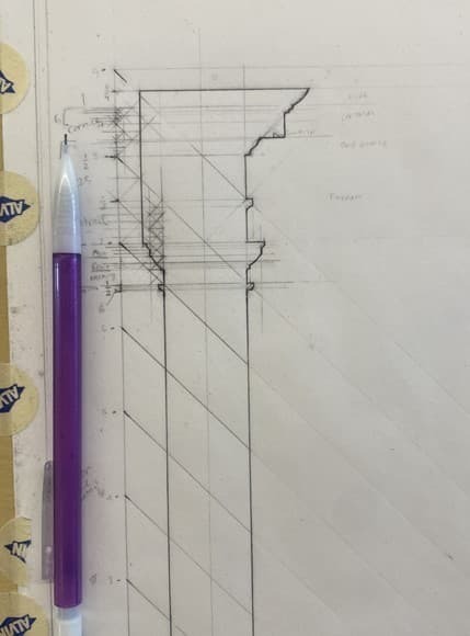 a purple pen next to a hand drawn graphic with diagonal lines running through it